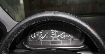 Torn and damaged leather steering wheel