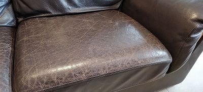 renovation of the seats of a full grain leather sofa in chocolate colour