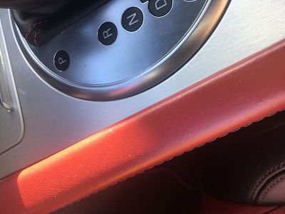 2010 audi tts seat with two-tone black and red leather interior.