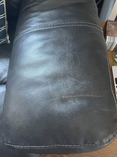 faded/worn black leather sofa